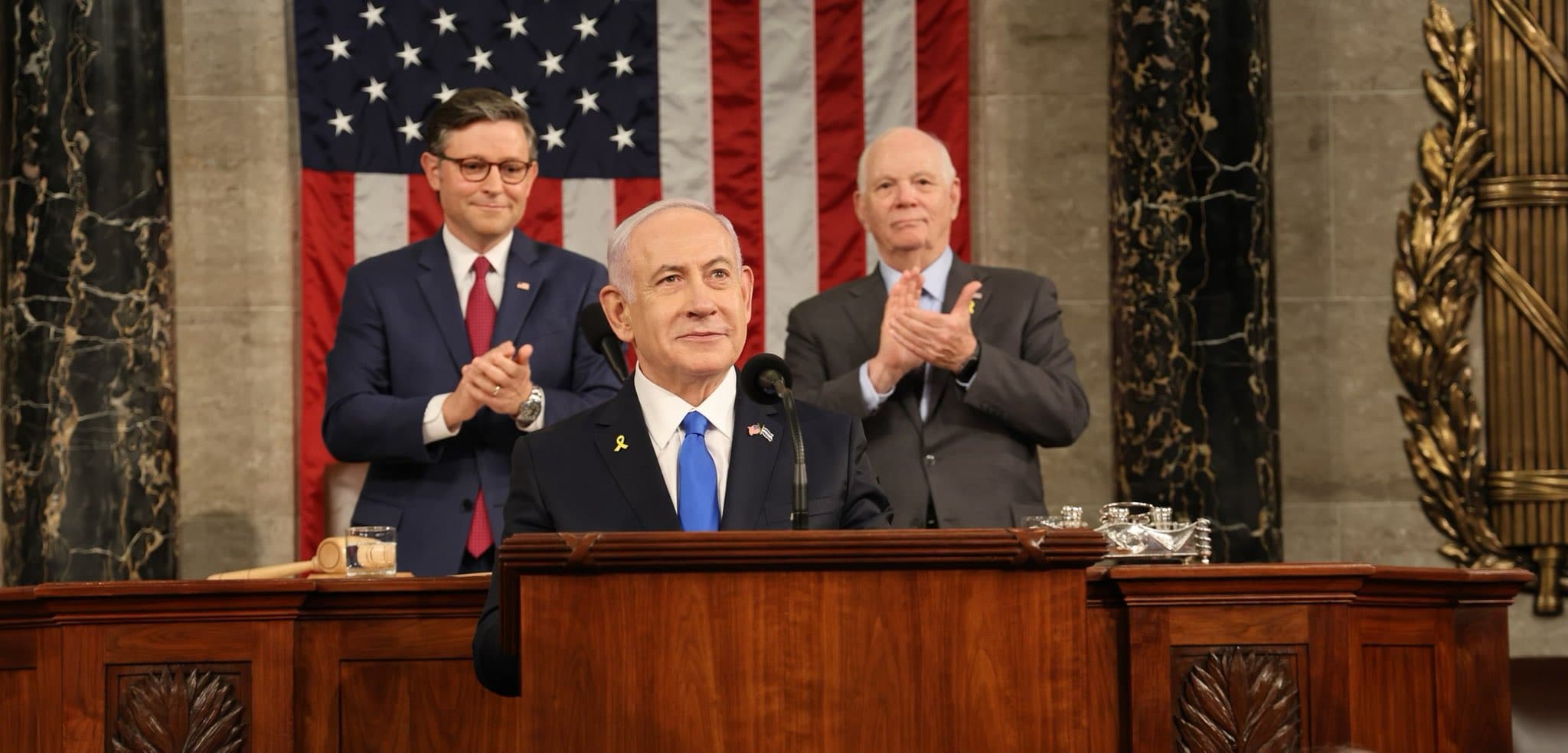 Israeli Prime Minister Benjamin Netanyahu addresses a joint meeting of the U.S. Congress as Speaker Mike Johnson and Sen. Ben Cardin applaud